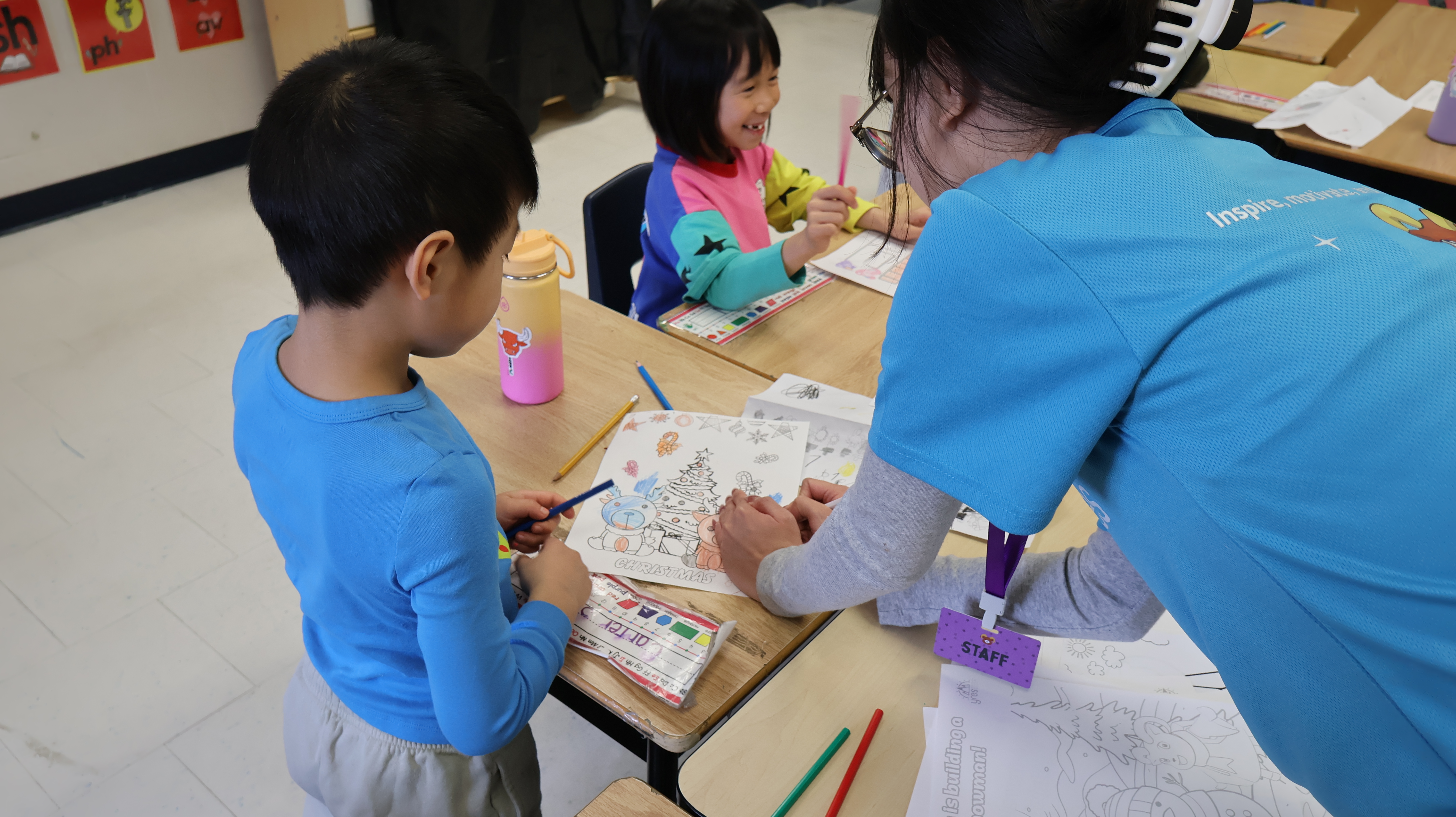 Volunteer Helping Child with Art